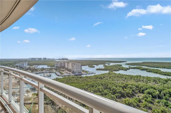 Water view featuring nearby urban area, bay, and a marina