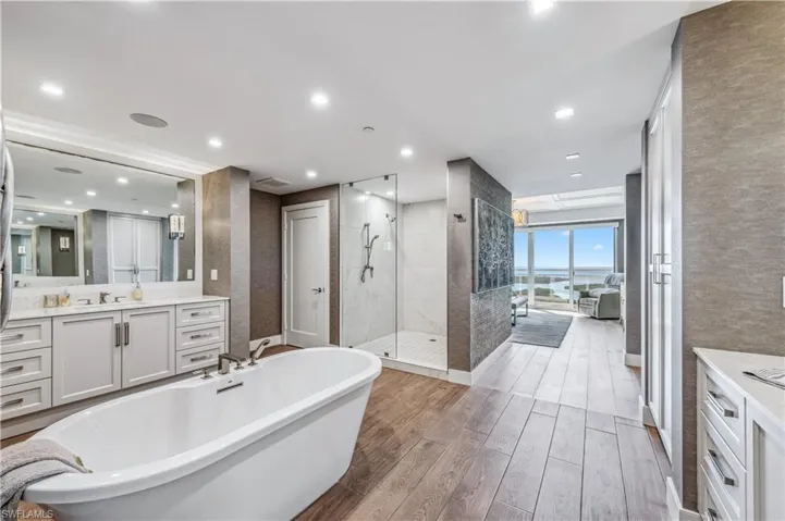 Master Bathroom featuring a shower stall, vanity, and a freestanding bath