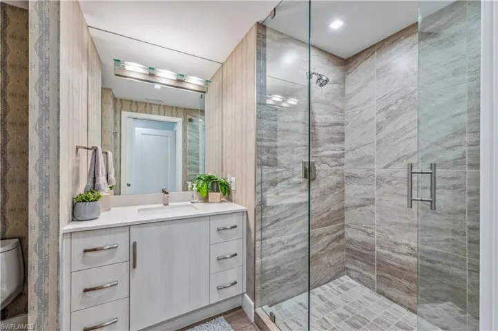Bathroom featuring vanity and a shower stall