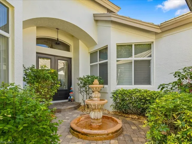 Property entrance featuring stucco siding, french doors, and a patio