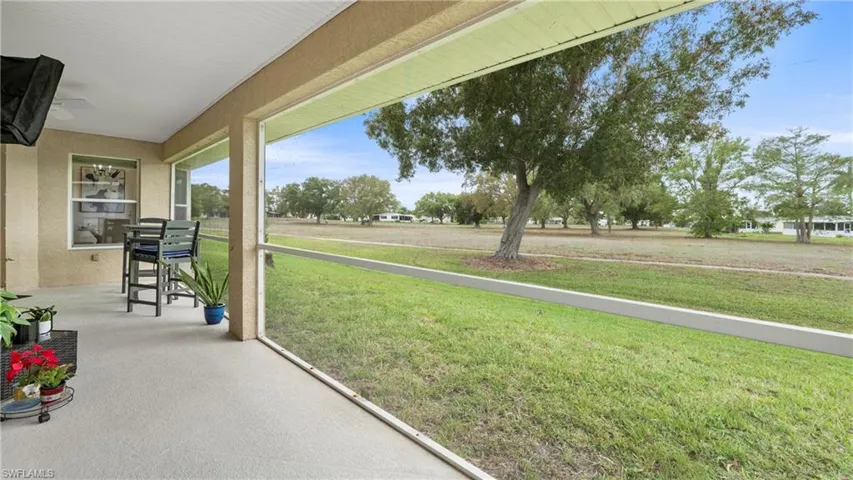 Unfurnished sunroom featuring a ceiling fan