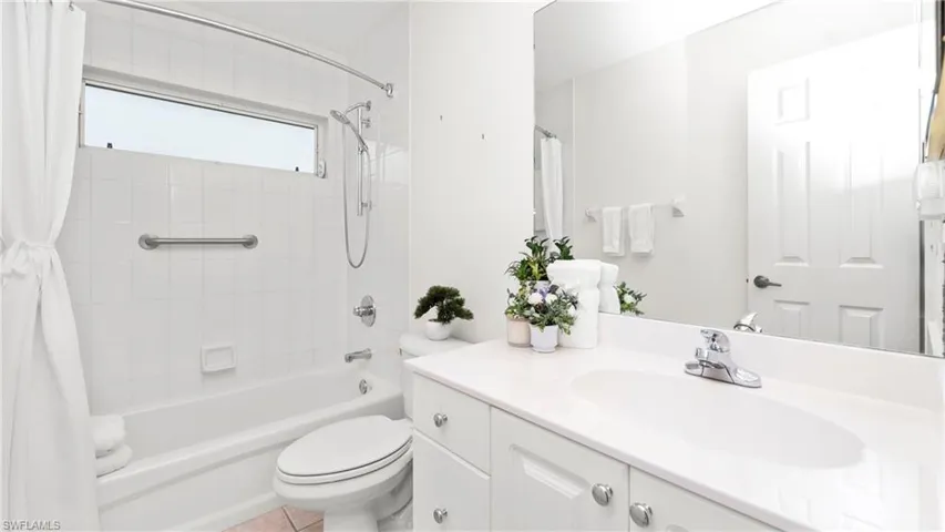 Bathroom with vanity and shower / bath combo with shower curtain