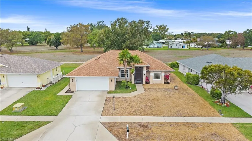 NEW SOD ON WAY!!! View of front of property featuring a front yard, concrete driveway, a shingled roof, stucco siding, and a garage