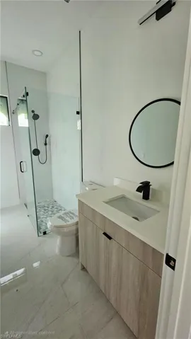 Bathroom with vanity and a shower stall