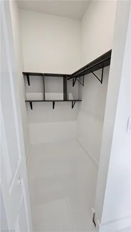 Walk in closet featuring light tile patterned floors