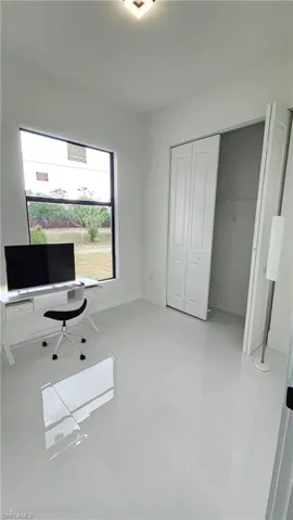 Unfurnished office with light tile patterned floors and baseboards