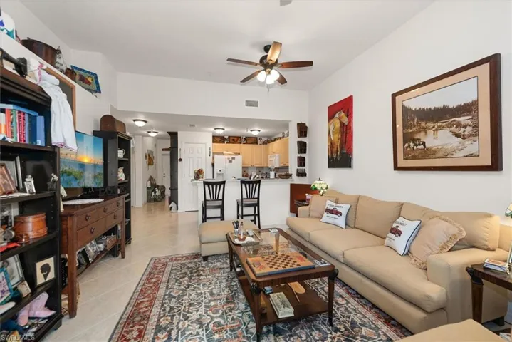 Living room showcasing open flow to the kitchen and foyer.