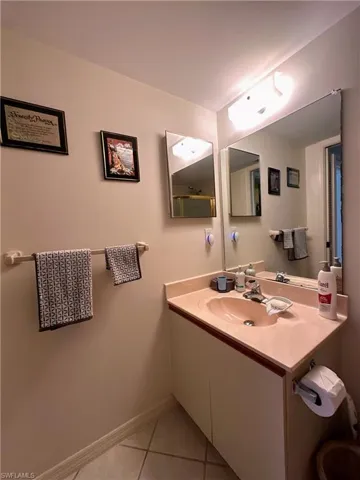 Bathroom featuring light tile patterned floors and vanity