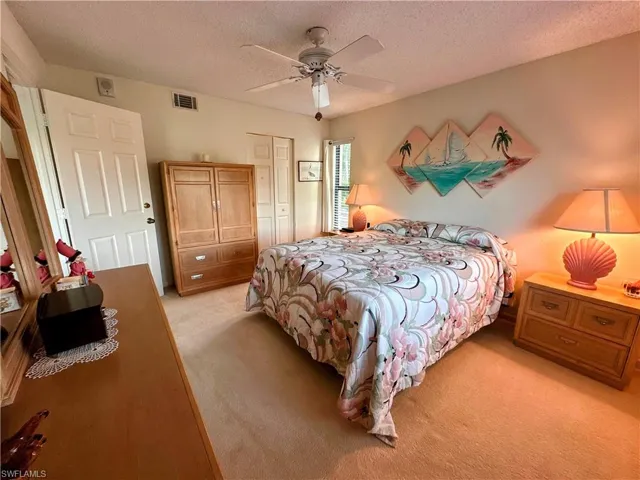 Large Bedroom with  a closet, light colored carpet, and a ceiling fan