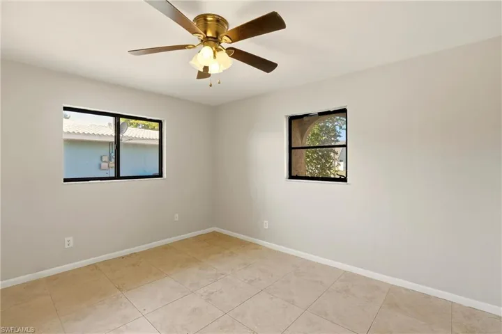 Spare room featuring baseboards and ceiling fan