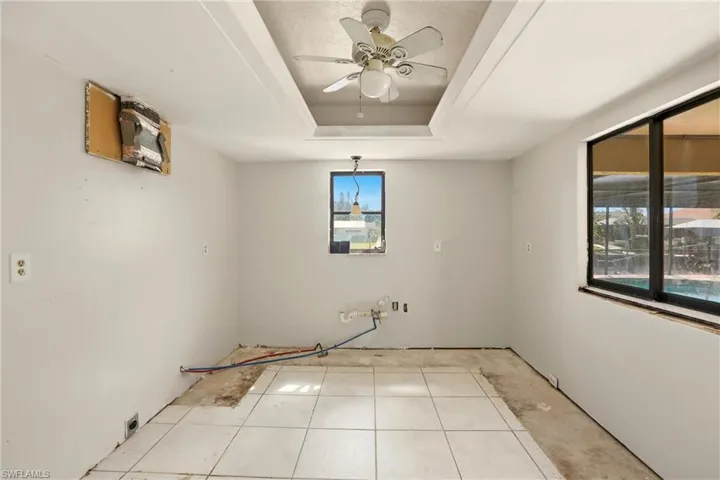 Spare room with a ceiling fan and a raised ceiling