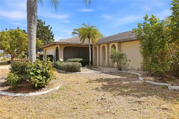 View of front of property featuring an attached garage, stucco siding, and a shingled roof