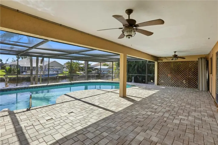 Outdoor pool with a patio, a lanai, a sunroom, and a residential view