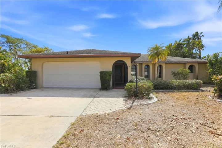 View of front of property with concrete driveway, stucco siding, and a garage