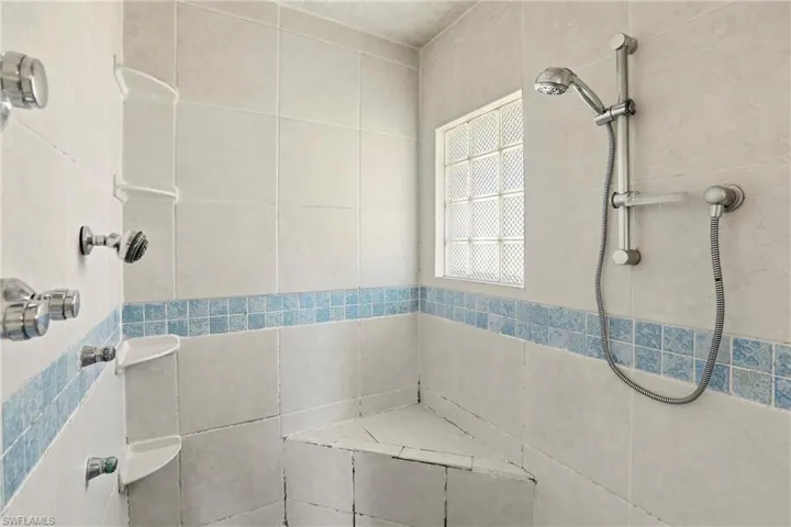 Full bath featuring a tile shower