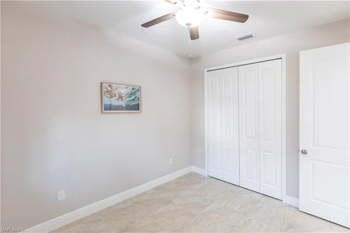 Unfurnished bedroom featuring a closet and ceiling fan