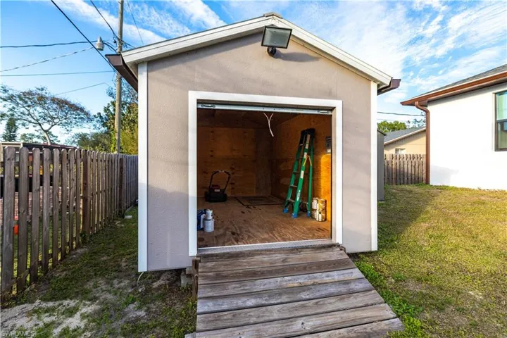 View of outbuilding featuring a lawn