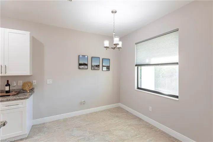 Unfurnished dining area featuring a chandelier