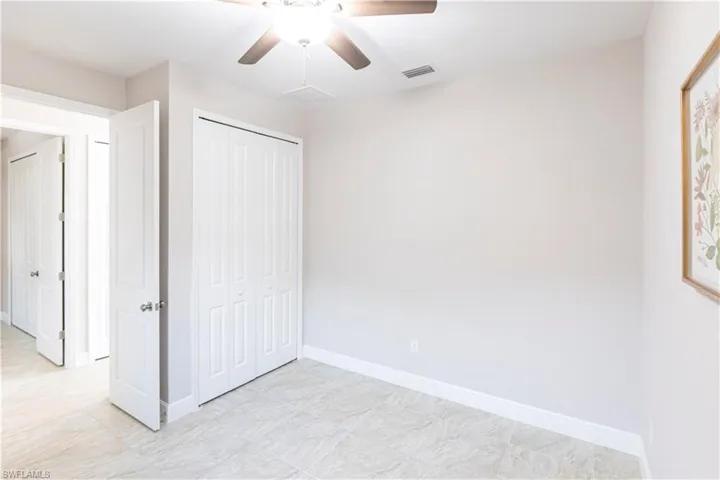 Unfurnished bedroom featuring ceiling fan and a closet