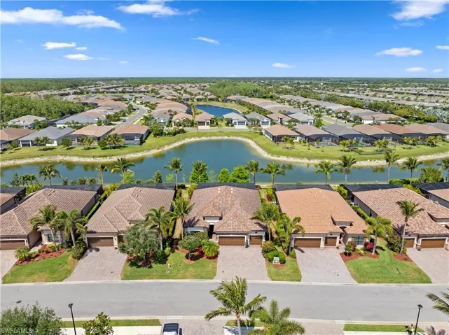 Drone / aerial view with a residential view and a water view