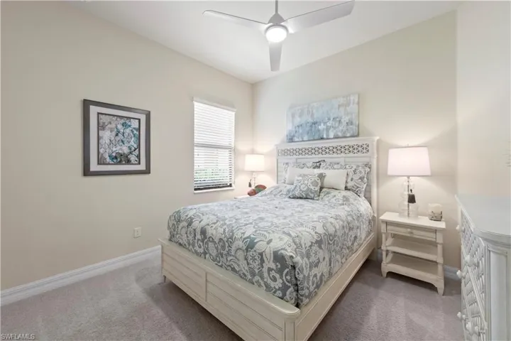 Bedroom featuring baseboards, ceiling fan, and carpet