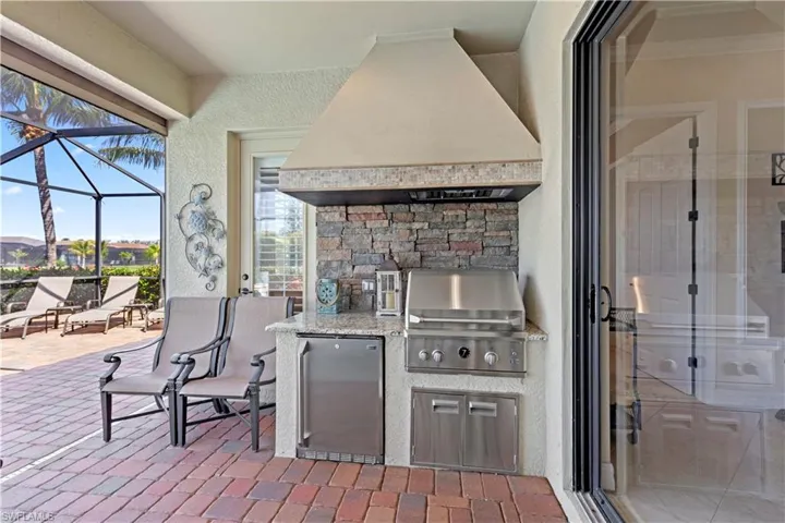View of patio with a grill, and outside kitchen