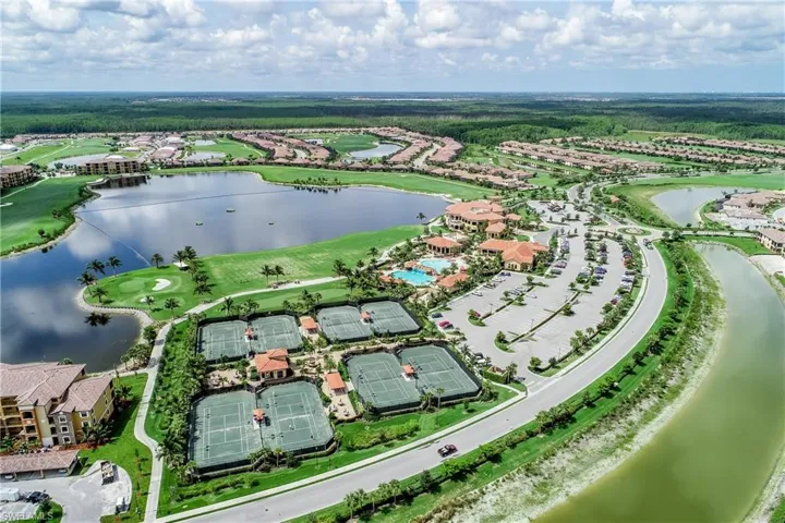 Aerial view with a water view and view of golf course