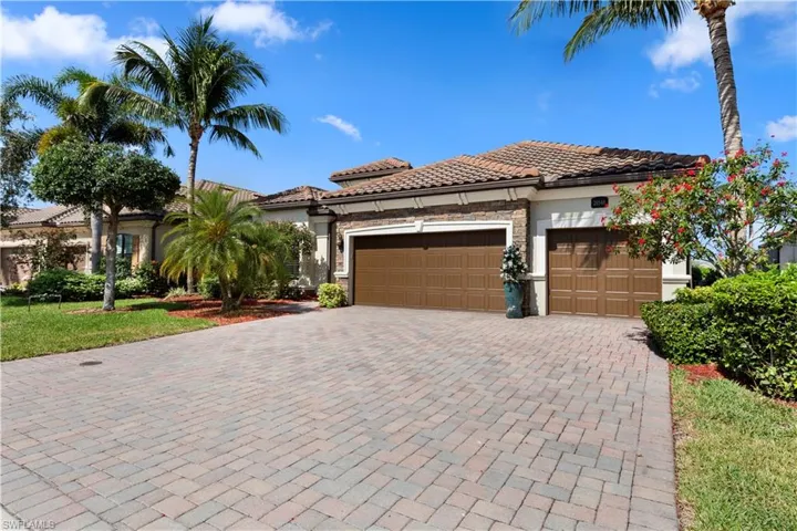 Mediterranean / spanish home featuring stone siding, a tiled roof, decorative driveway, stucco siding, and a 3-car garage