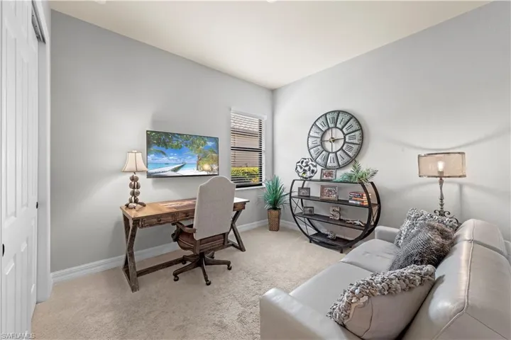 Office with baseboards and carpet flooring