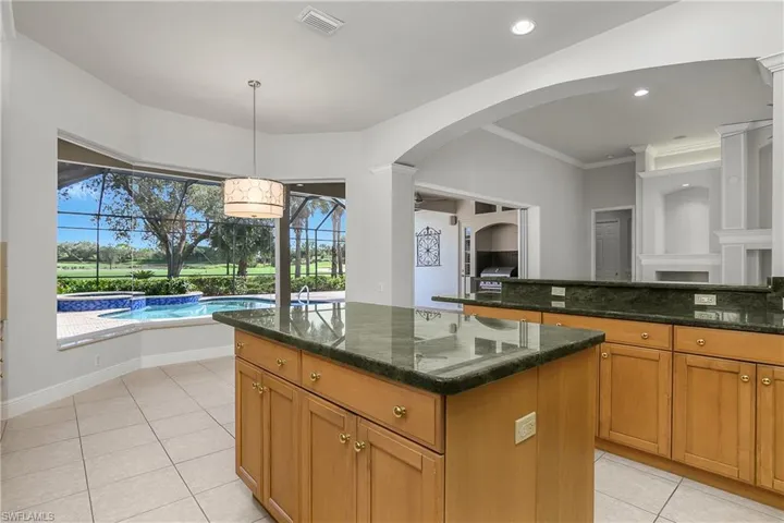 Large center island, granite counters, mitered glass window breakfast nook with unobstructed view of pool, spa and oversized deck.