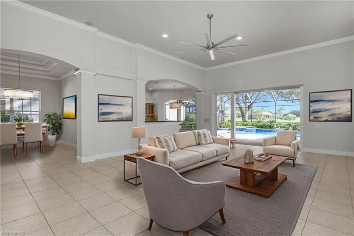 Note: The house is being offered unfurnished and all pictures showing furniture are photographically staged. The house is vacant of all furnishings. Great room with new fan and LED lighting, open visibility to and from the kitchen, dining room to left and open "pocketed" slider doors to oversized lanai.