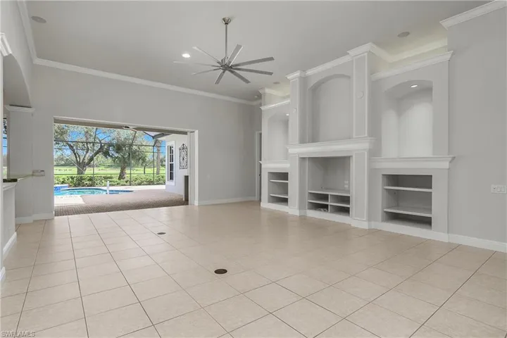 Great room, sliders "pocket" behind right wall allowing open visibility to lanai and golf view beyond.