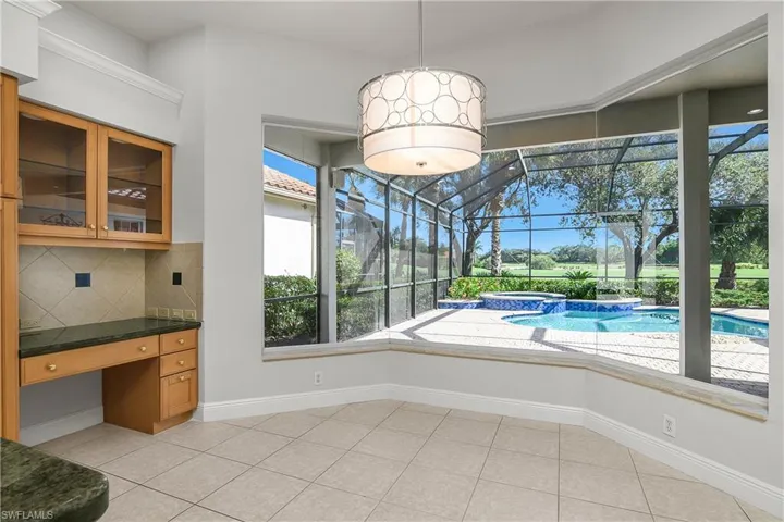 New chandelier, built in planning desk, glass cabinetry above
