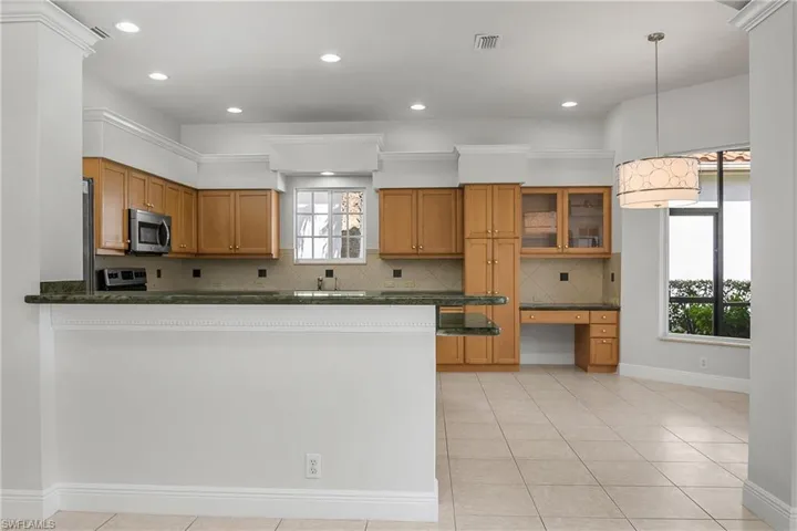 Kitchen completely open to great room. New chandelier, new LED lighting