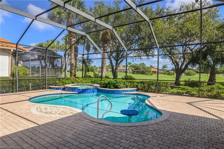 Pool and spa with built in pool ledge and table for relaxation.