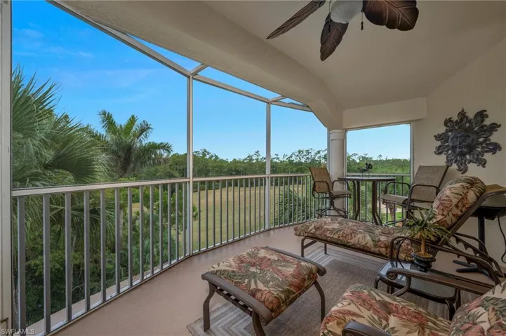 Sunroom with a ceiling fan and lofted ceiling