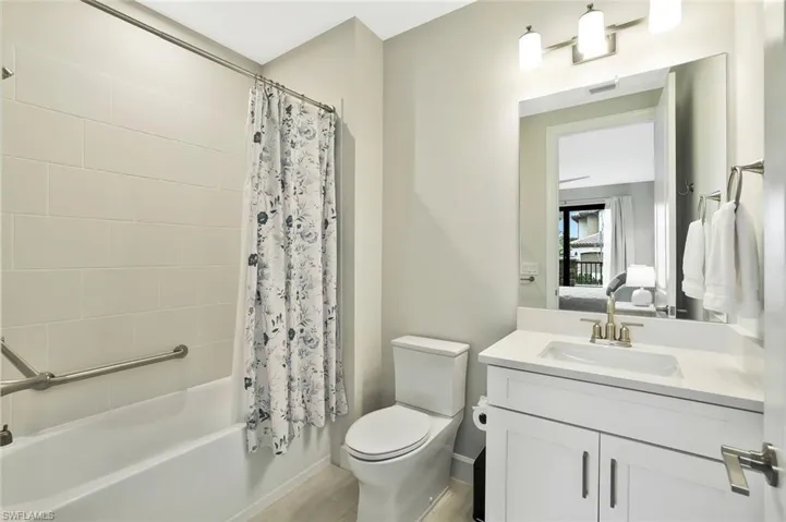 Ensuite bathroom featuring vanity and shower / bath combo