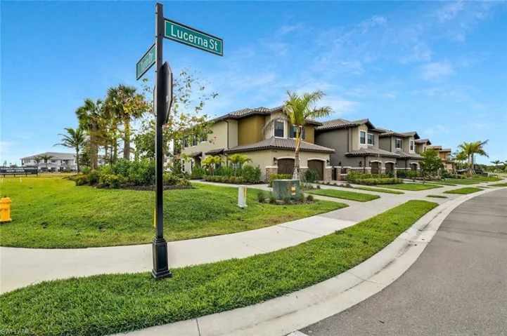 Mediterranean / spanish home featuring stucco siding, a front lawn, a tile roof, and a garage