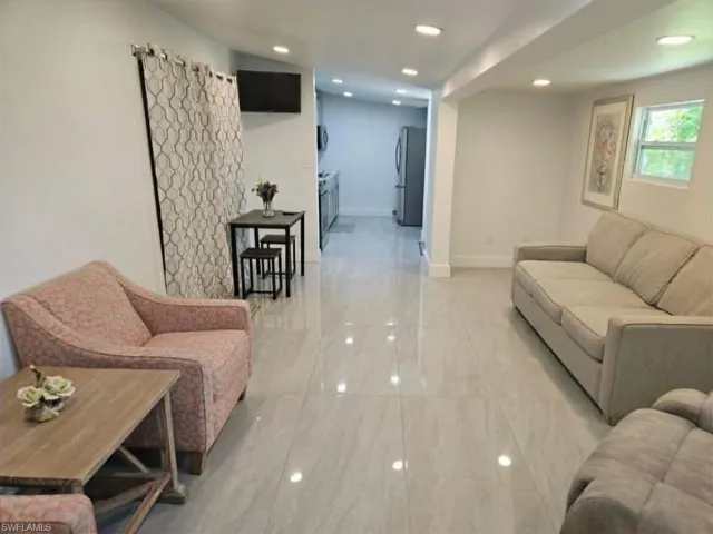 Efficiency: Living room looking down towards the kitchen area.