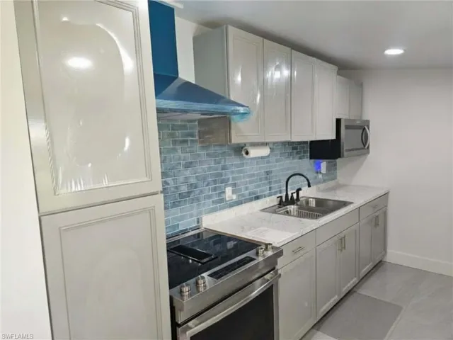 Efficiency: Kitchen, with stainless steel appliances.  NOTE: the plastic wrap is still on most of the cabinets and the blue comes off the vent, all protected until you are ready to move in!