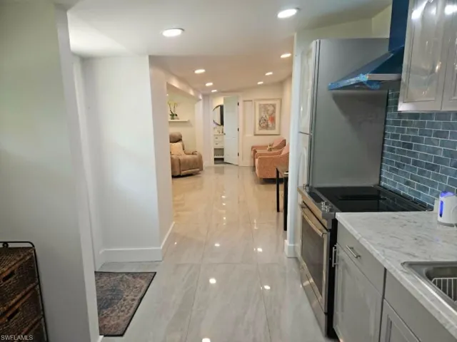 Efficiency: - Notice the luxurious big tile as you look from kitchen down into the living space and the bathroom/laundry at the end.