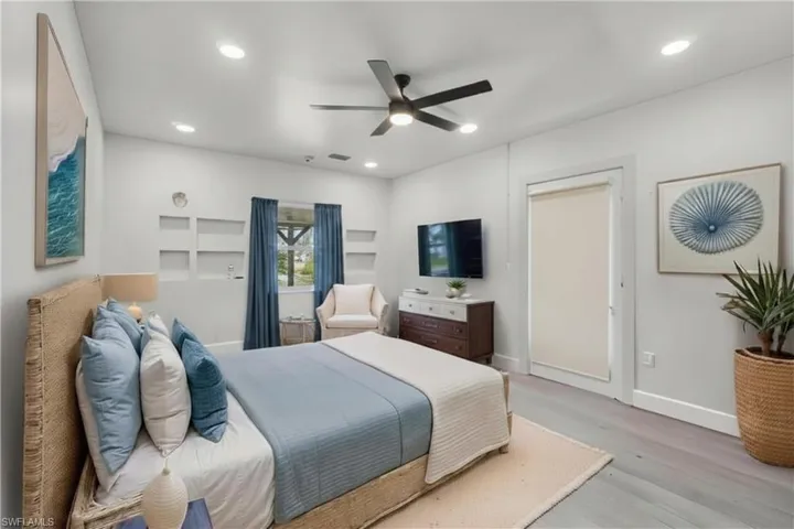 Main House - The primary bedroom includes a private exterior door, providing convenient direct access to the outside. (Bedroom has been virtually staged)