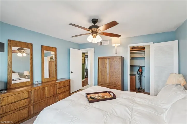 Bedroom with a spacious closet and ceiling fan