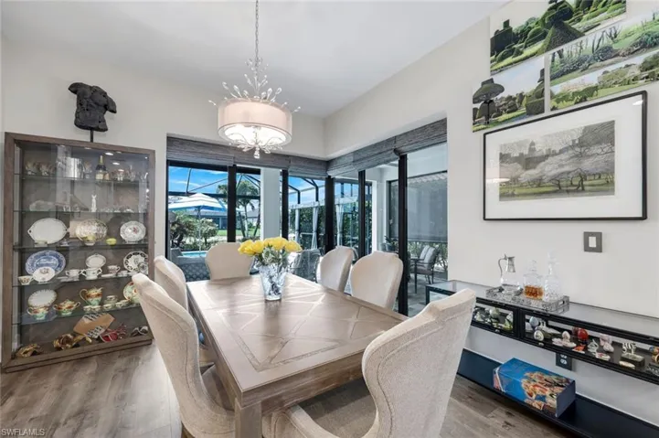 Dining area featuring wood-finish flooring and a decorative chandelier