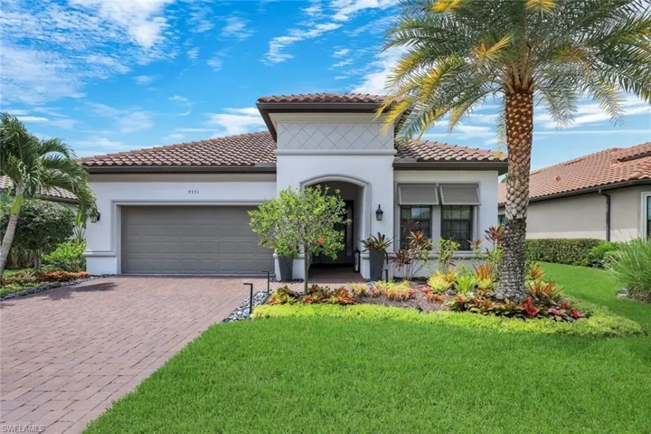 Mediterranean-inspired exterior with a tile roof and stucco finish