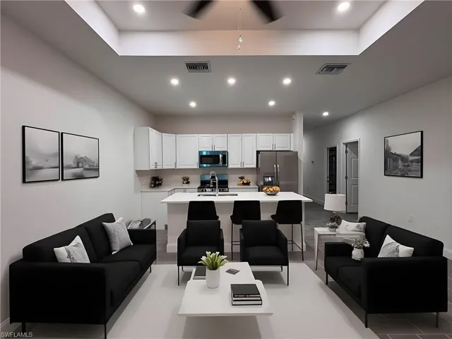 Living room with recessed lighting and a ceiling fan