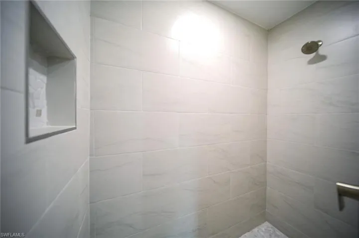 Full bathroom with a tile shower