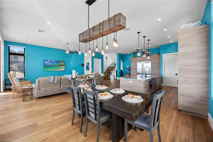 Dining area featuring ceiling fan and light wood floors