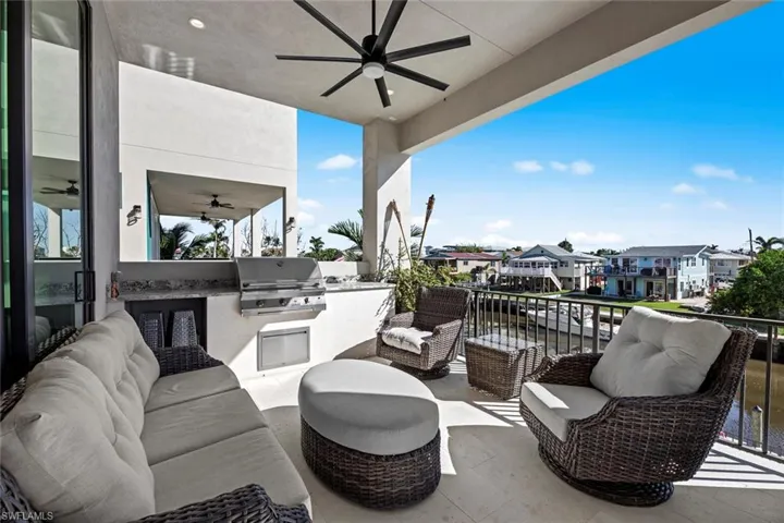 View of patio with ceiling fan, a balcony, an outdoor hangout area, and area for grilling