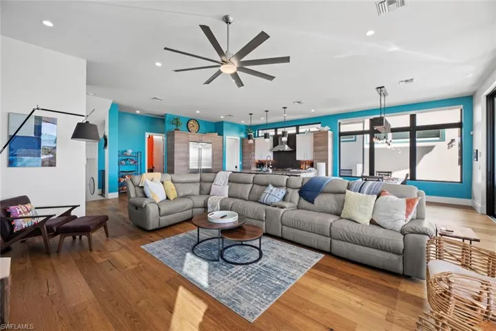 Living room featuring ceiling fan and light hardwood / wood-style flooring